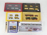 a lot of different model trains in boxes on the table