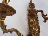pair of antique brass wall sconces with a man and woman face