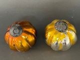 two pumpkins that are sitting on a table