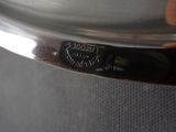 a close up of a person ' s hand holding a silver plate