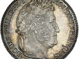a silver coin with an image of a man ' s head on it
