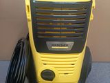 a yellow and black portable heater sitting on the floor