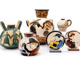 many different types of vases on display on a white surface