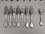 a lot of forks and spoons that are on the table