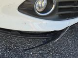 a close up of a car ' s front bumper and grille