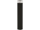the black cylinder lamp is next to a white wall