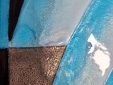a close up of a blue and white cake with icing on it