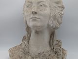 sculpture of a woman ' s head on a stone base