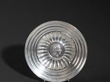 an antique silver plate on a black background with a black background