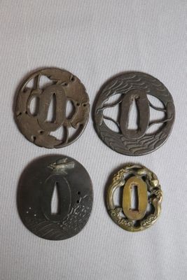 four different types of japanese tsubai with gold and silver decorations