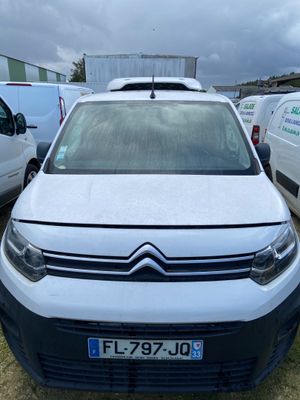 a white citrole parked in a lot next to other cars