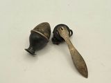 two small metal objects that are on a white surface