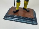 a statue of a man with a hat and a cane