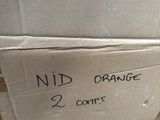 a cardboard box with a sign on it that says mid orange