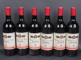 six bottles of red wine lined up in a row