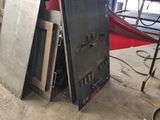 several pieces of metal are stacked on top of each other in a warehouse