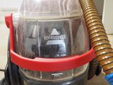 a vacuum that is sitting on the floor with a hose