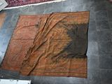 a brown rug on the floor next to a radiator
