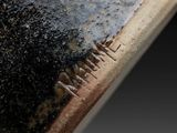 a close up of a piece of metal with rust on it