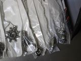 a lot of silver necklaces that are on a table