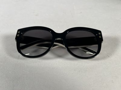 a pair of black sunglasses sitting on top of a table
