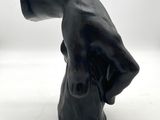 a black statue of a dog with a hat on it ' s head