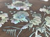 a close up of a table with flowers and leaves on it