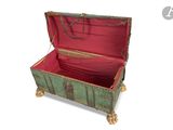 a green trunk with a red lining on the inside