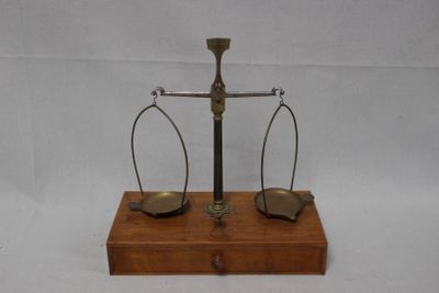 a wooden stand with two metal scales on it