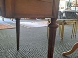 a wooden table with a drawer underneath it in a room