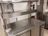 a kitchen with stainless steel counter tops and stainless steel cabinets