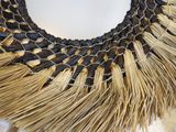 a close up of a necklace made out of straw