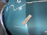 a sticker on the hood of a blue car