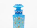 blue glass bottle with a gold and blue design on it