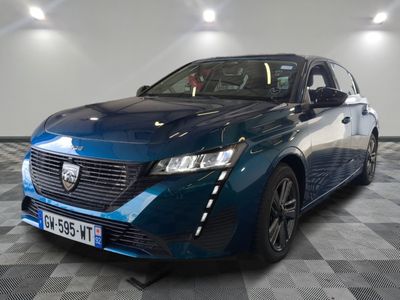 the blue car is parked on a checkered floor in a garage