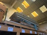 a large stack of metal beams in a warehouse