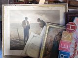 a picture of a man and a woman standing next to a pile of books
