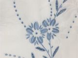 blue and white floral design on a white napkin