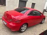 a picture of a red car parked in front of a building