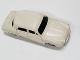 a toy car that is sitting on a white surface