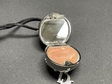 a small silver box with a mirror and a keychain attached to it