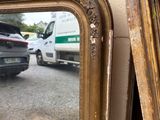 two mirrors that are next to each other on the wall