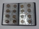 an open book with a bunch of coins in it on a table