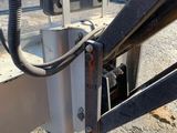 a close up of a truck ' s front end with a hose attached to it