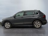the volkswagen tiguan is parked in a parking lot with a sky background