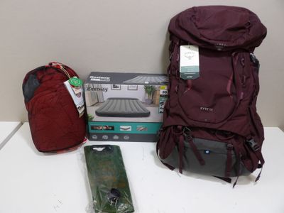 a backpack, a cell phone, and other items on a table