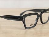 glasses on a wooden table with a white wall in the background