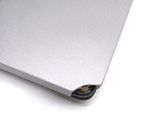 a close up of a silver laptop on a white surface