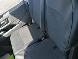 two seats in the back of a car with luggage on the floor