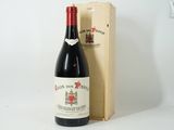 a bottle of wine sitting next to a wooden box